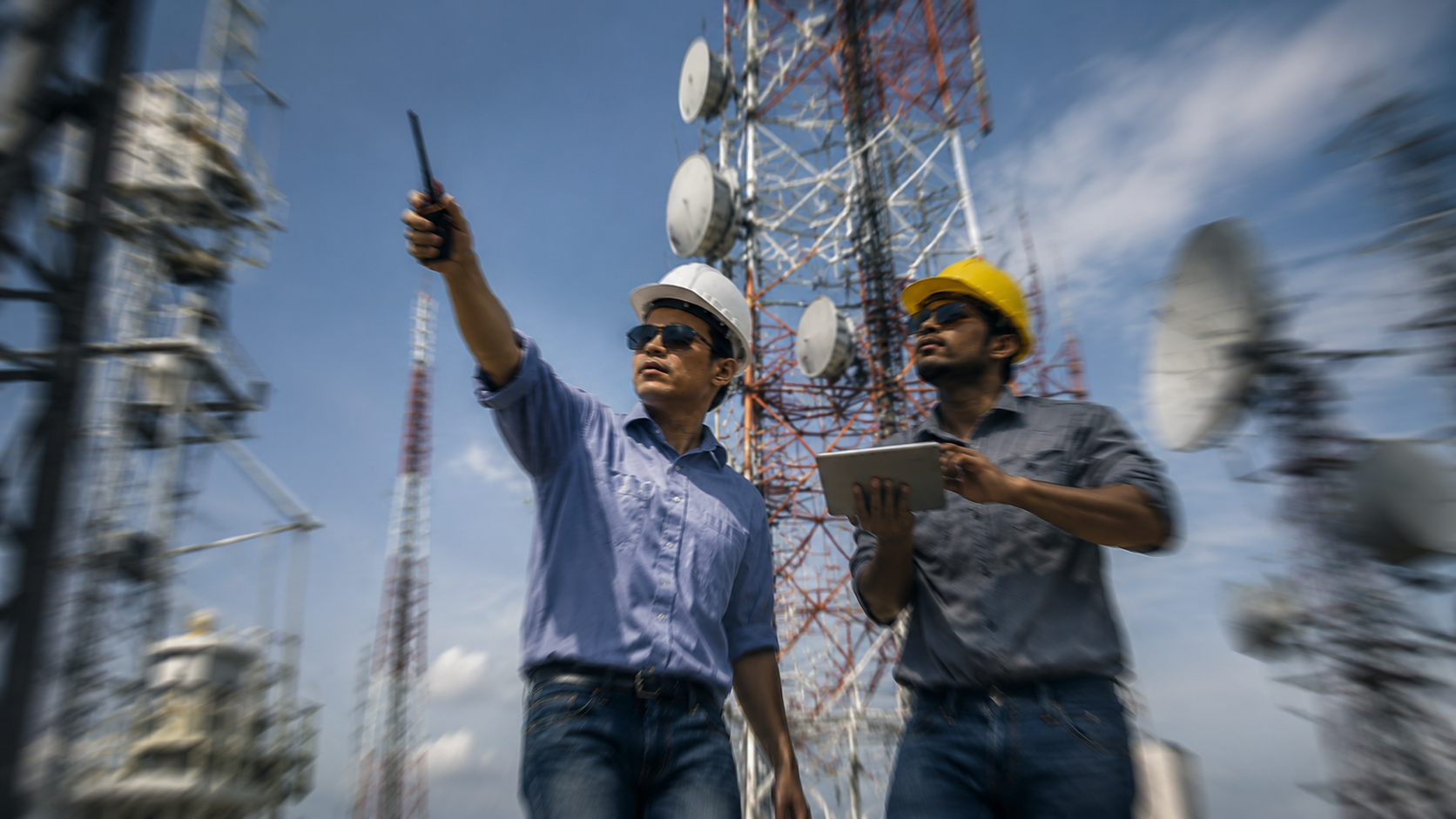 Telecom field engineers inspecting network towers